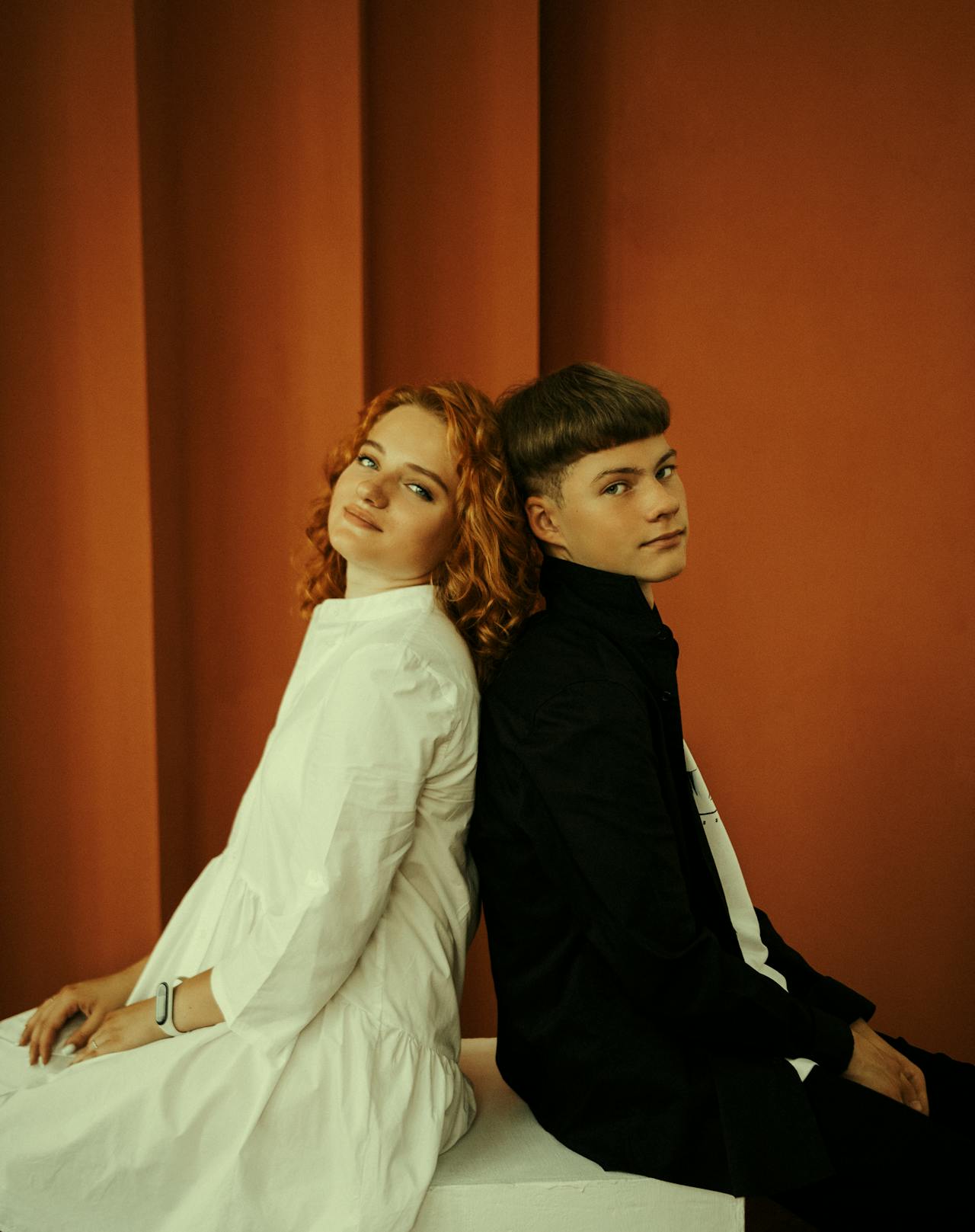 A couple sitting in silence, each turned away